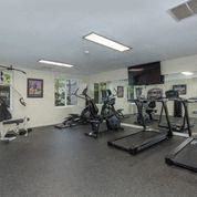 A room filled with lots of different types of exercise equipment